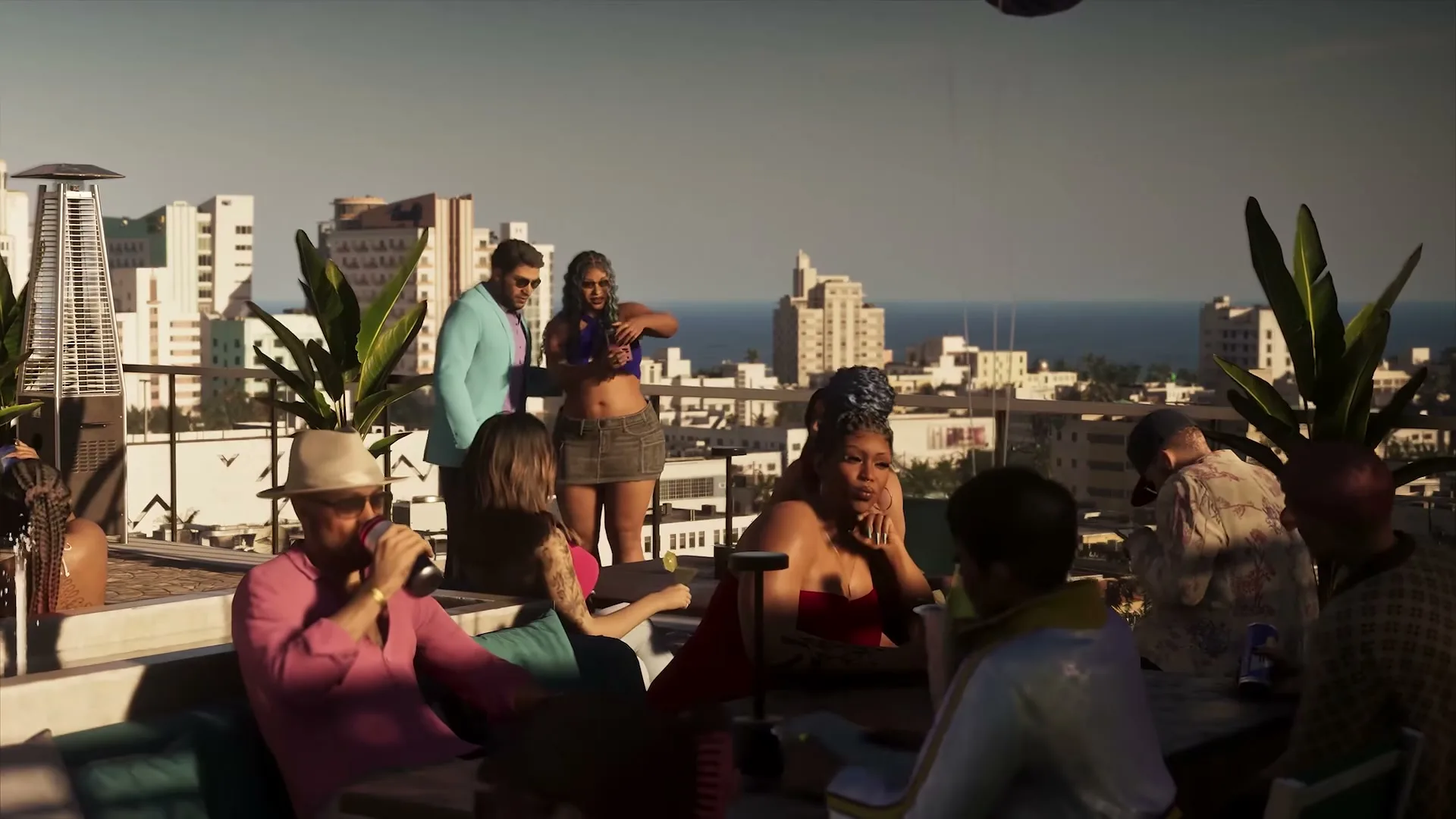 Friends drinking on a rooftop terrace in Vice City, the ocean behind them.