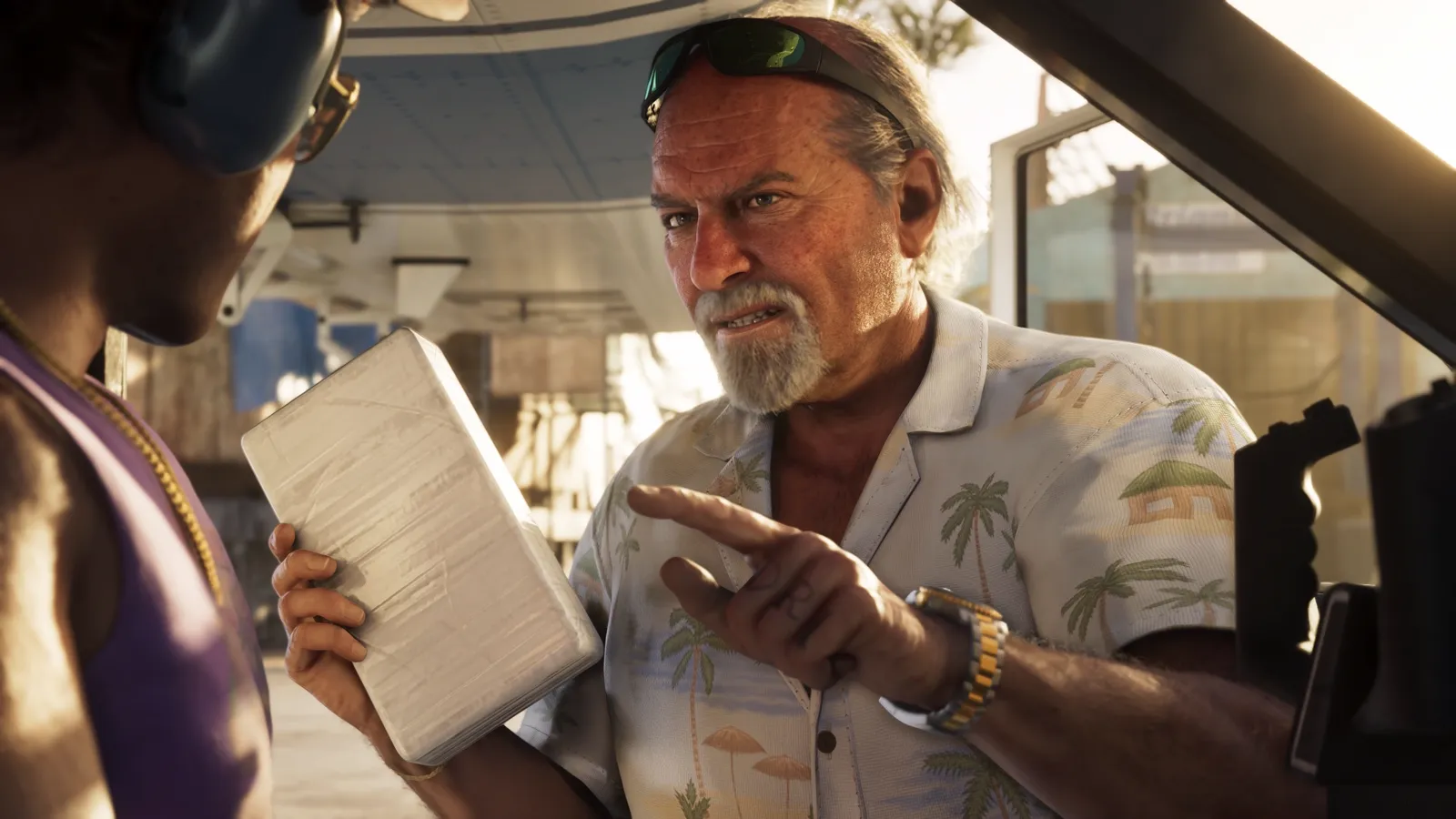Brian holding a package and pointing at a man in a plane.