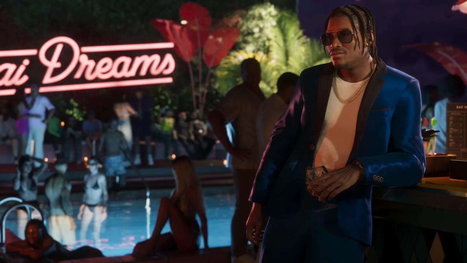 Dre'Quan in a suit at a nighttime pool party.