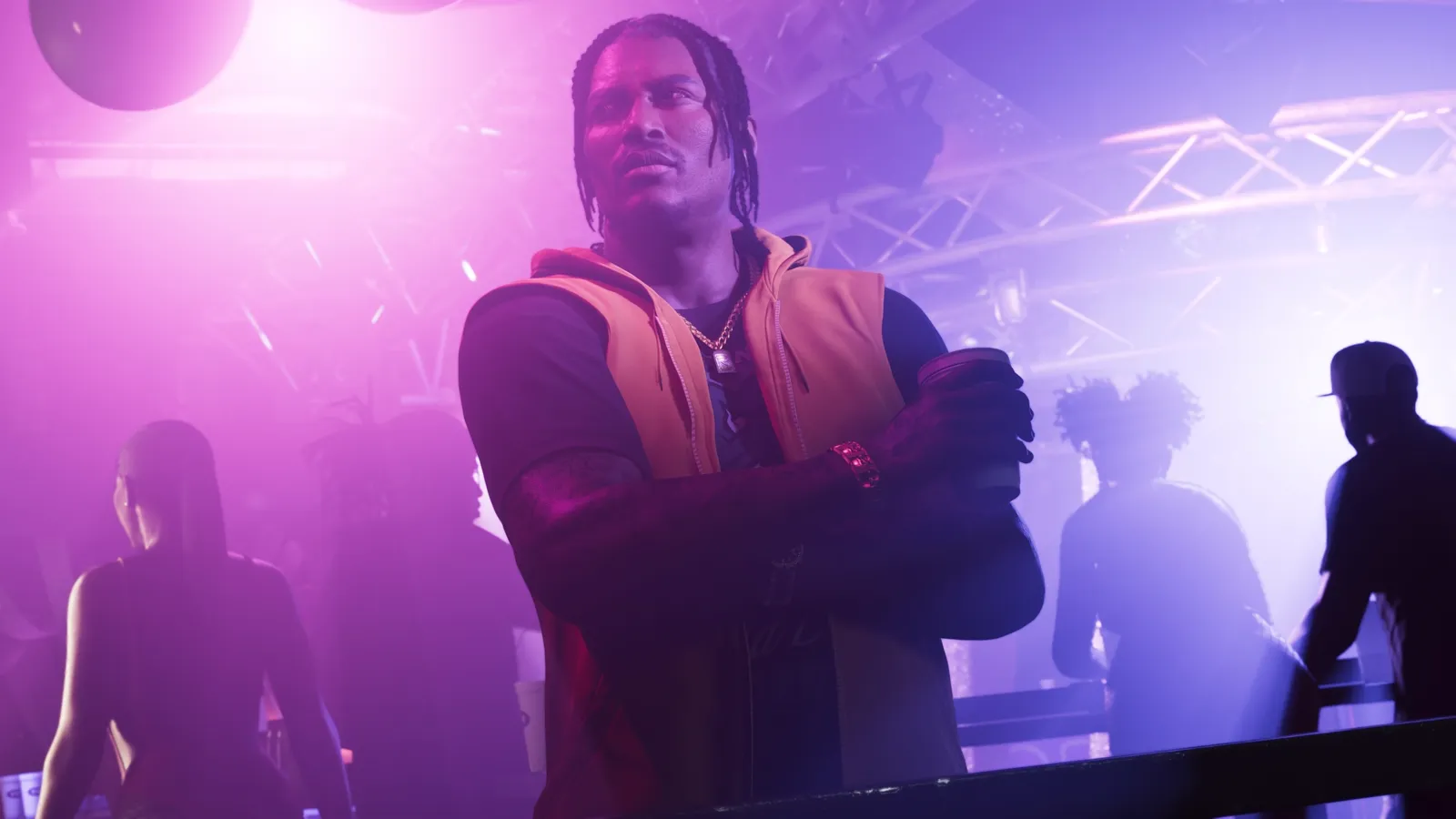 Dre'Quan in a club, arms crossed.
