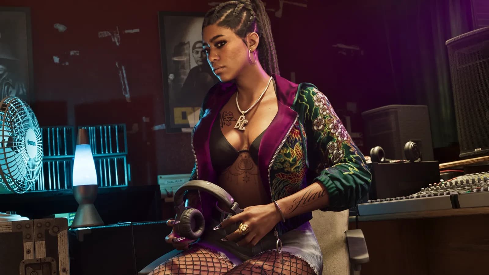 Bae-Luxe of the Real Dimez in a recording studio holding headphones.