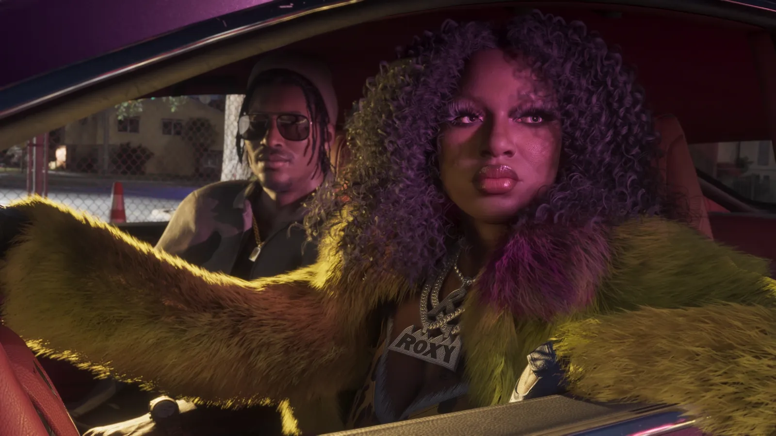 Roxy of the Real Dimez at the wheel, Dre'Quan in the passenger seat.