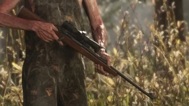 Hunter in camouflage holding a scoped bolt-action rifle in tall grass, from an official GTA 6 screenshot