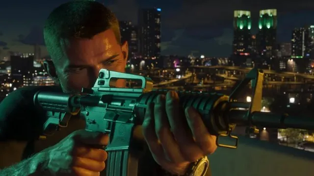 Man aiming a green-tinted AR-style rifle from a rooftop with a night city skyline behind him, from an official GTA 6 trailer frame