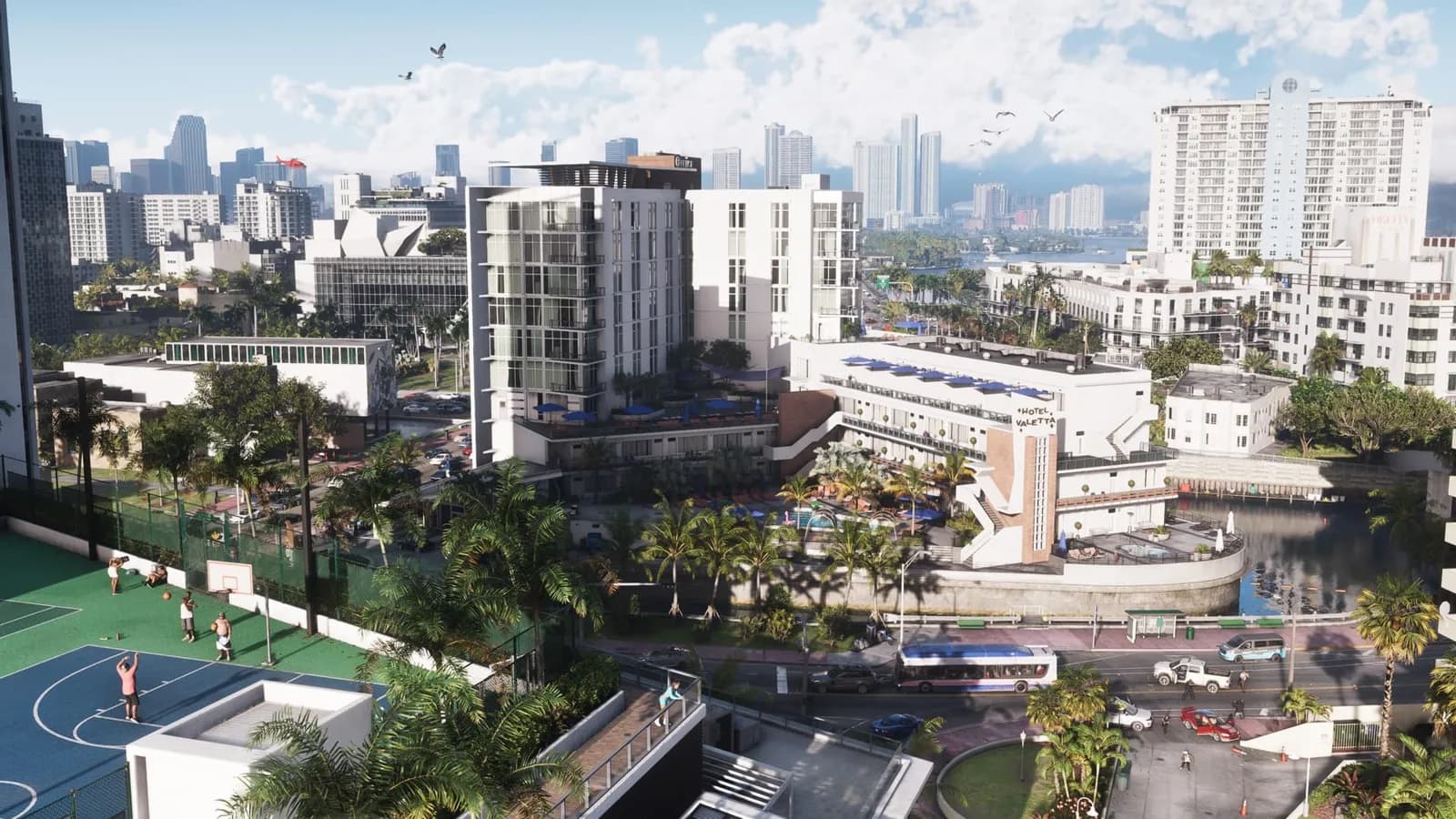 A view of Vice City with roads, palm trees, a basketball court and towers in the background.